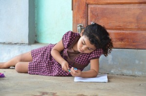 Fellow traveler Katharine caught this great shot of a little girl studying at the primary school.